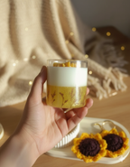 Hand holding a glass of dessert with a blurred background