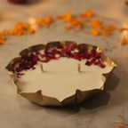 Decorative oil lamp with flowers on a stone surface